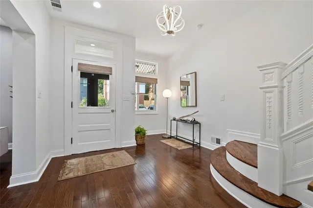 a living room with furniture and a view of kitchen