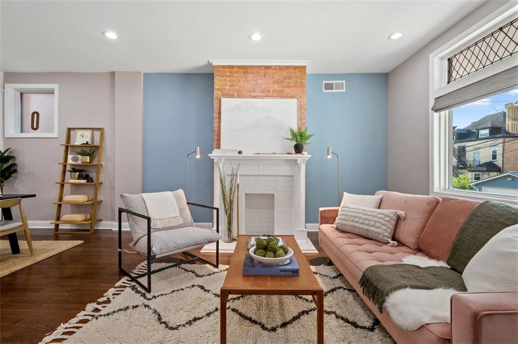 5531 Columbo Street Pittsburgh, PA 15206 - Photo 6 of 34 a living room with furniture and a fireplace