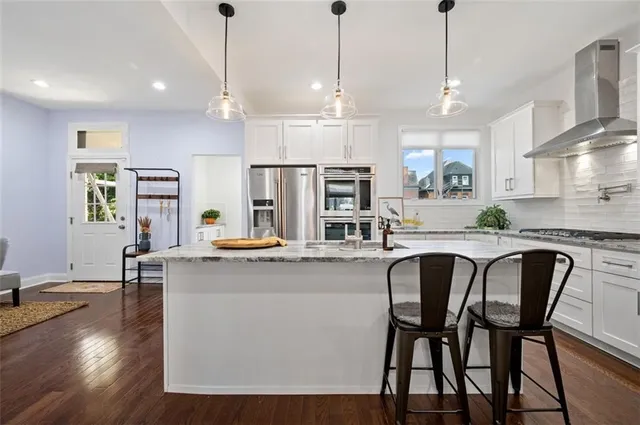 a kitchen with cabinets and wooden floors