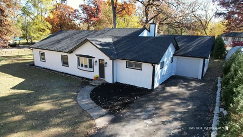 a aerial view of a house with a yard