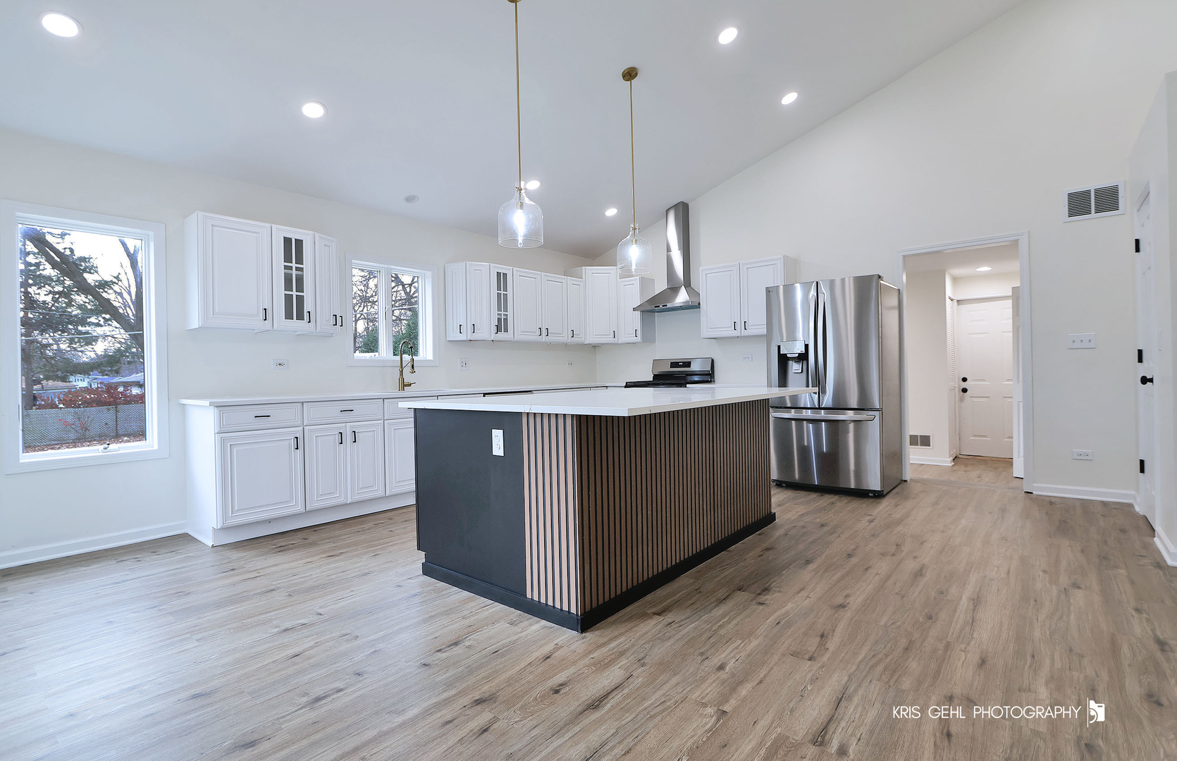 18653 West Willow Point Road Grayslake, IL 60030 - Photo 11 of 49 a kitchen with stainless steel appliances granite countertop a sink a stove a refrigerator and island with wooden floor