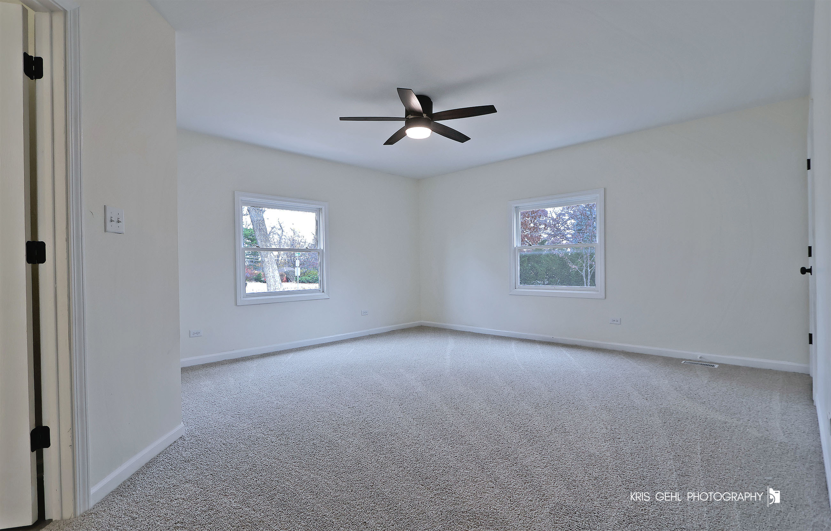 18653 West Willow Point Road Grayslake, IL 60030 - Photo 19 of 49 an empty room with windows and ceiling fan