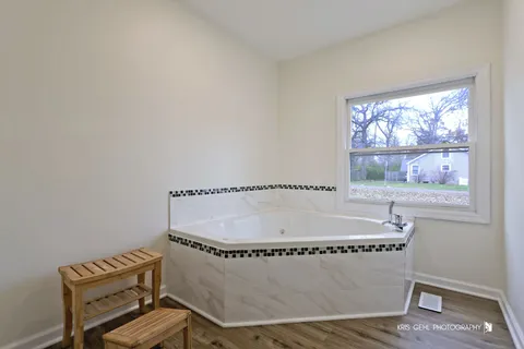 a room with a table chair and wooden floor