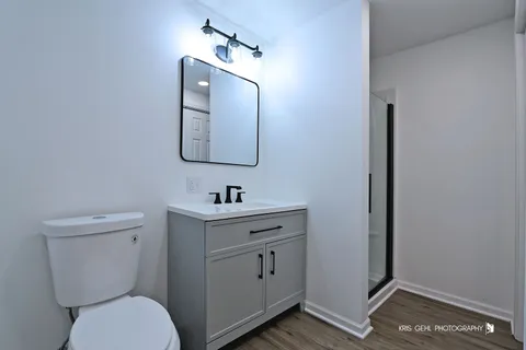 a bathroom with a toilet a sink a vanity and mirror