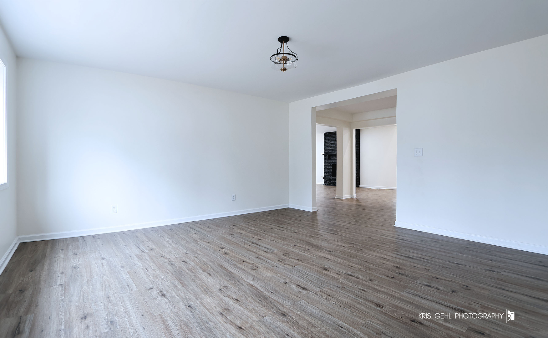 18653 West Willow Point Road Grayslake, IL 60030 - Photo 4 of 49 a view of an empty room with wooden floor and a window