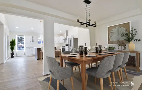 a dining room with furniture a chandelier and wooden floor