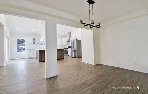 a view of a big room with wooden floor and a ceiling fan