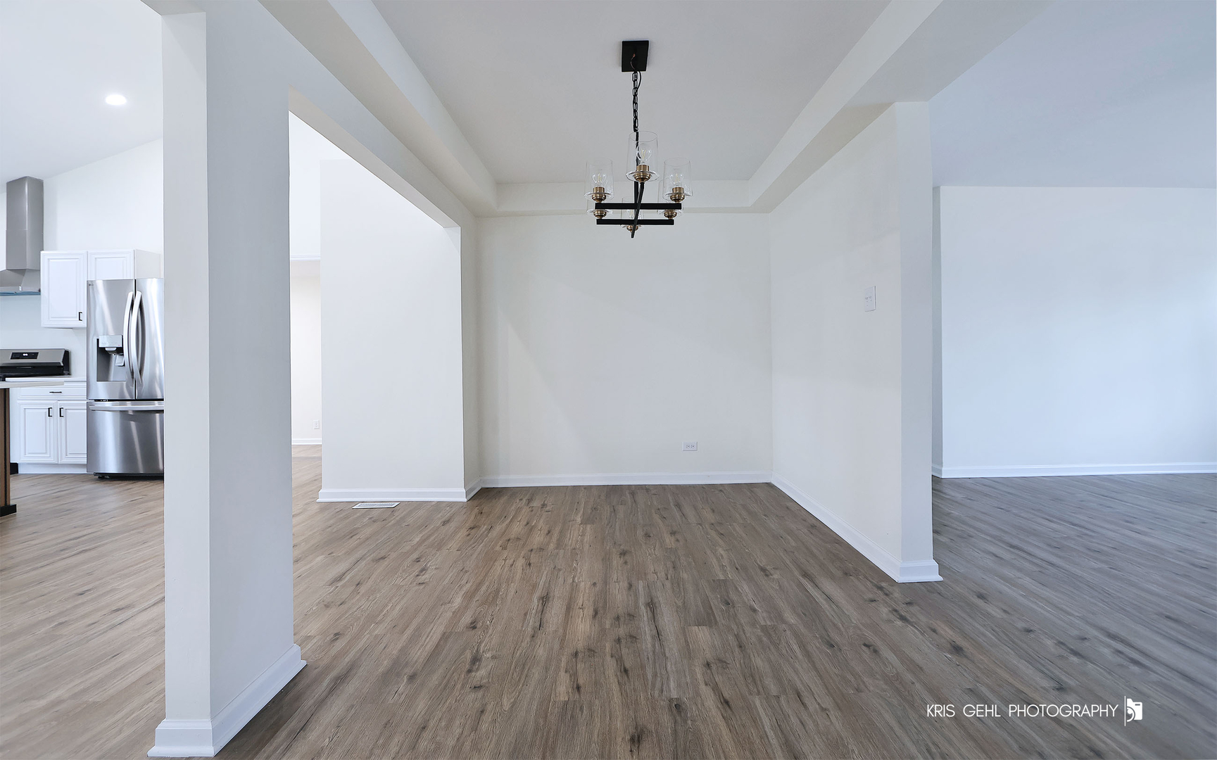 18653 West Willow Point Road Grayslake, IL 60030 - Photo 8 of 49 a view of a hallway with wooden floor and a ceiling fan