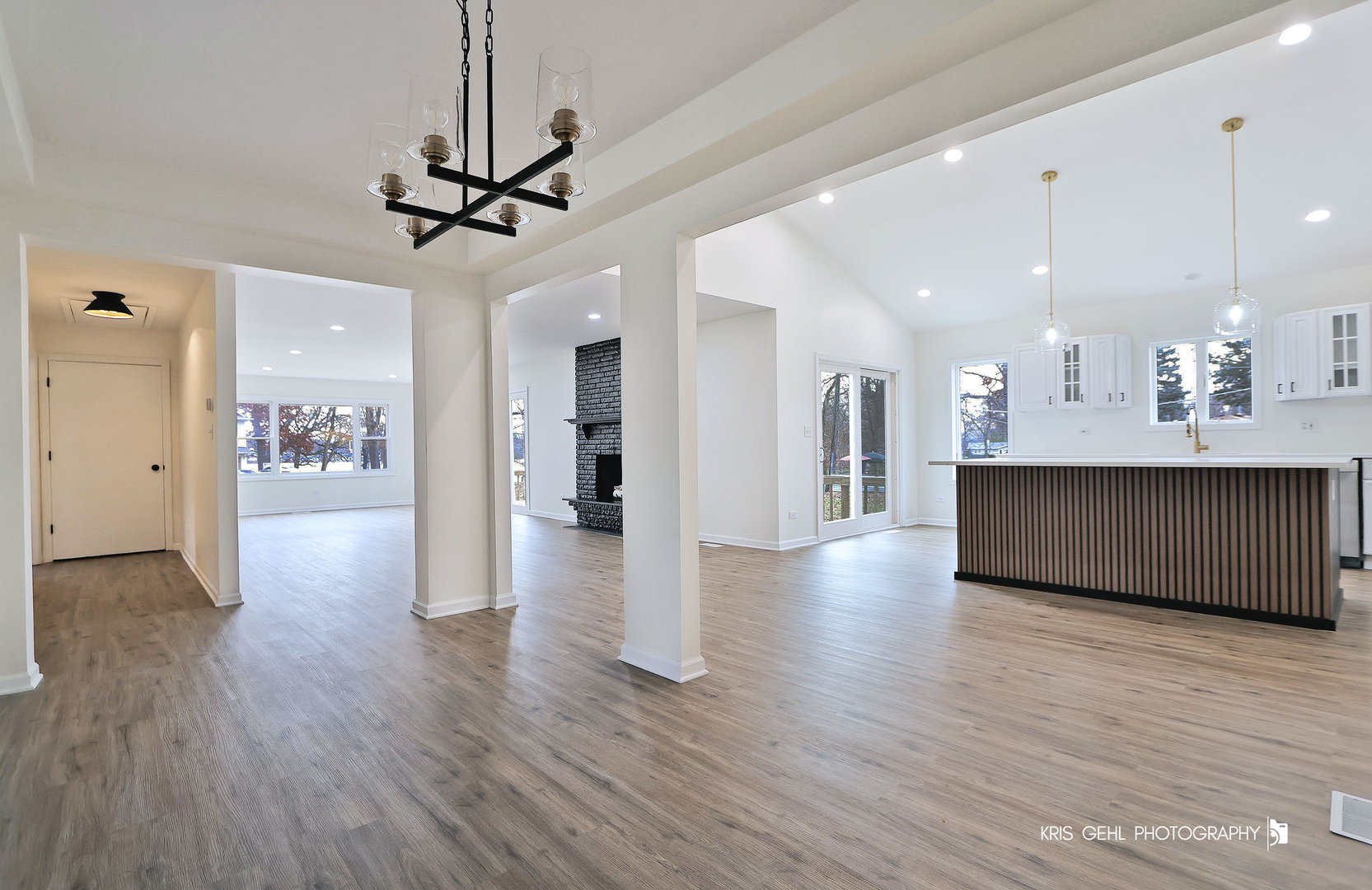 18653 West Willow Point Road Grayslake, IL 60030 - Photo 9 of 49 a view of a hallway with wooden floor and a kitchen
