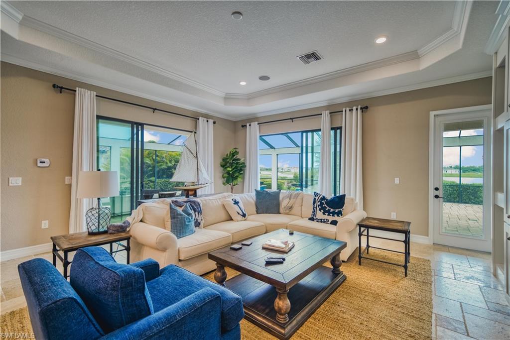 9902 Corso Bello Drive Naples, FL 34113 - Photo 11 of 45 a living room with furniture and a large window