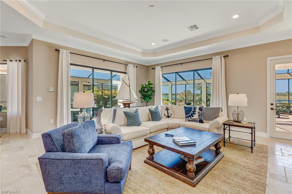 9902 Corso Bello Drive Naples, FL 34113 - Photo 12 of 45 a living room with furniture and a large window