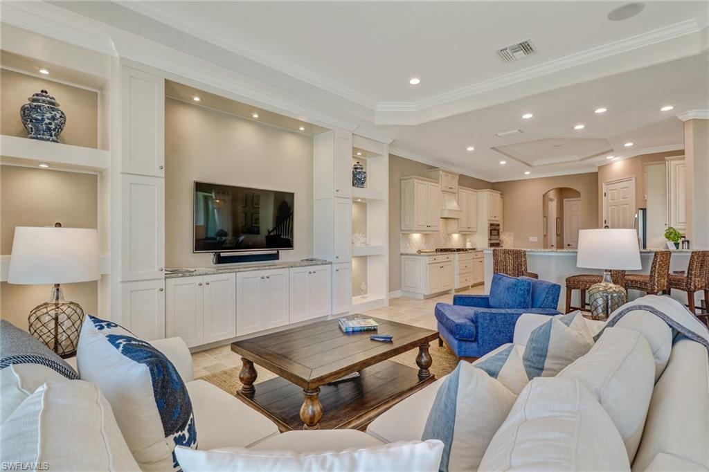 9902 Corso Bello Drive Naples, FL 34113 - Photo 13 of 45 a living room with furniture and a flat screen tv