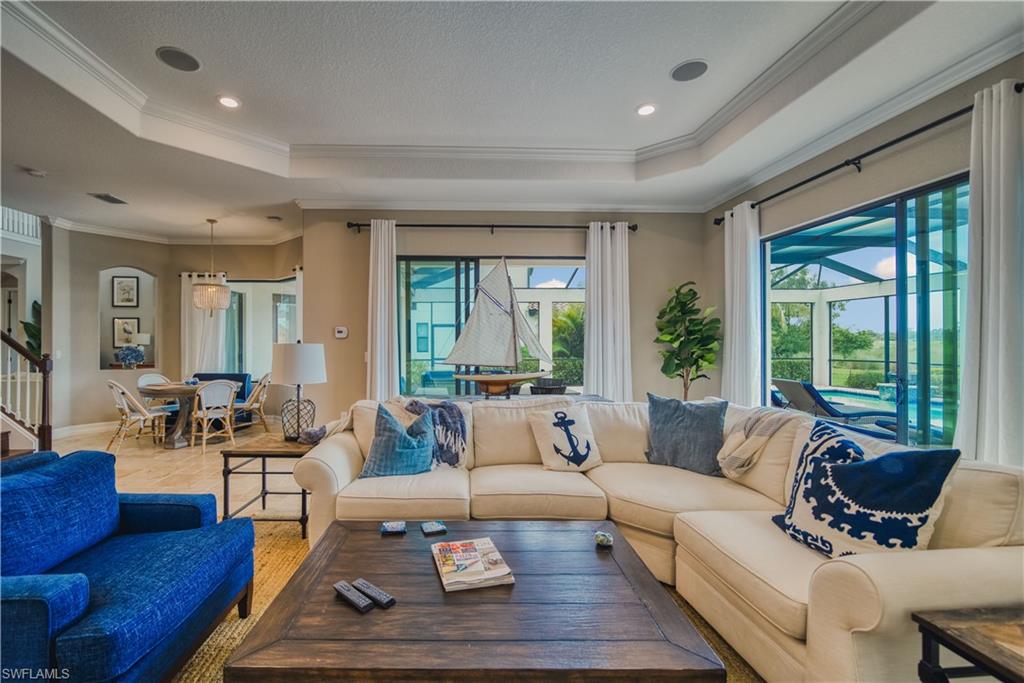 9902 Corso Bello Drive Naples, FL 34113 - Photo 14 of 45 a living room with furniture and a large window