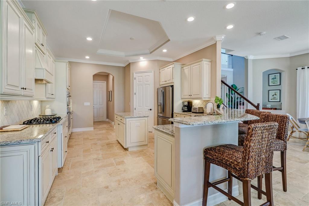 9902 Corso Bello Drive Naples, FL 34113 - Photo 17 of 45 a kitchen that has a lot of cabinets in it and appliances