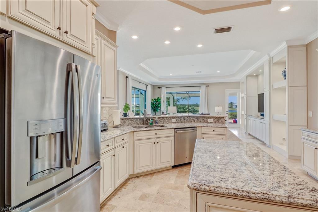 9902 Corso Bello Drive Naples, FL 34113 - Photo 19 of 45 a large bathroom with a granite countertop double vanity sink a mirror and a shower