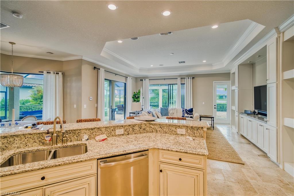 9902 Corso Bello Drive Naples, FL 34113 - Photo 21 of 45 a large white kitchen with granite countertop a sink and dishwasher with a large window