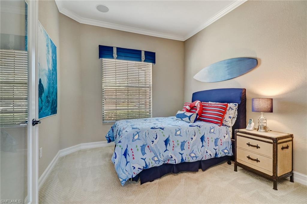 9902 Corso Bello Drive Naples, FL 34113 - Photo 22 of 45 a bedroom with a bed and a dresser