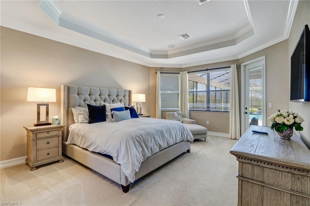 9902 Corso Bello Drive Naples, FL 34113 - Photo 23 of 45 a bedroom with a large bed and a tv