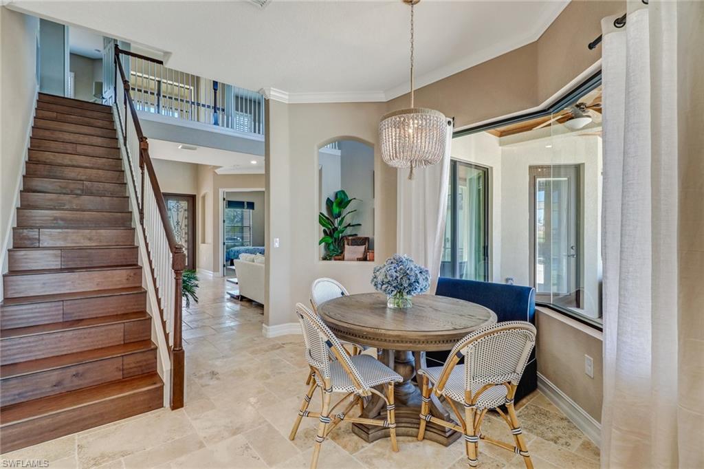 9902 Corso Bello Drive Naples, FL 34113 - Photo 27 of 45 a view of a dining room with furniture and wooden floor