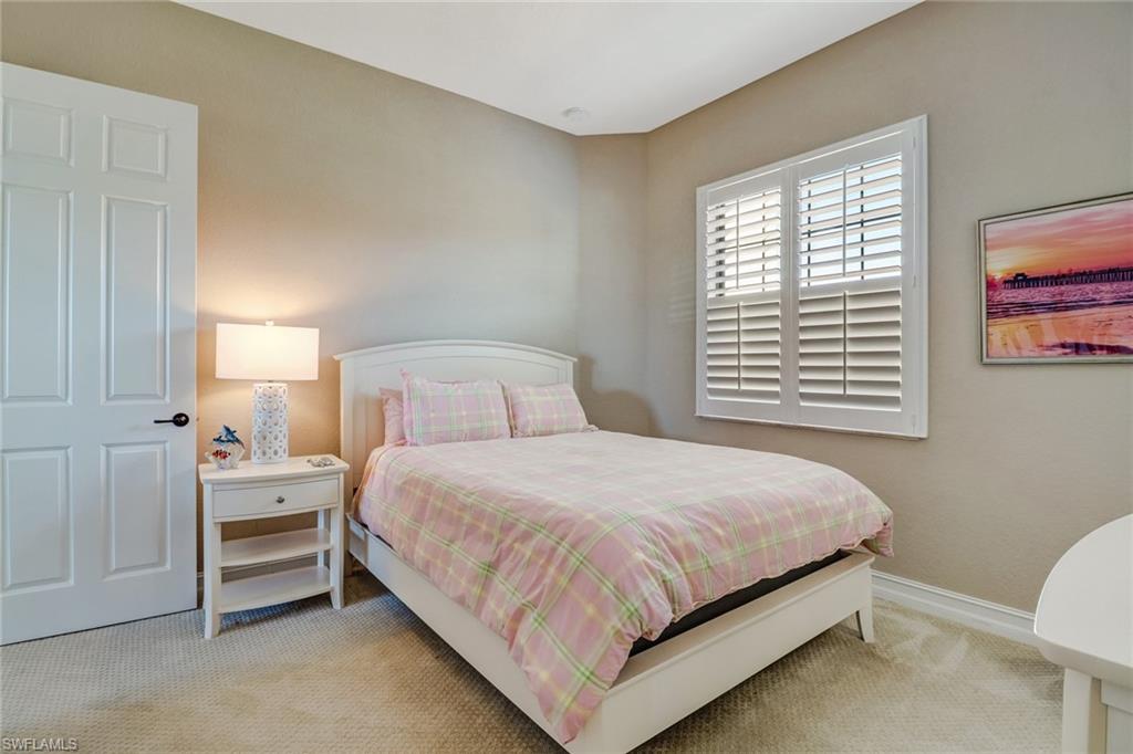 9902 Corso Bello Drive Naples, FL 34113 - Photo 29 of 45 a bedroom with a bed and a window