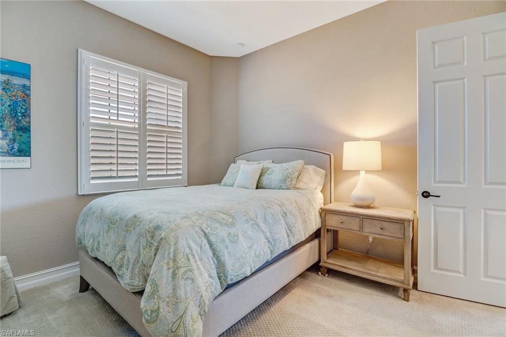 9902 Corso Bello Drive Naples, FL 34113 - Photo 30 of 45 a bedroom with a bed and a window