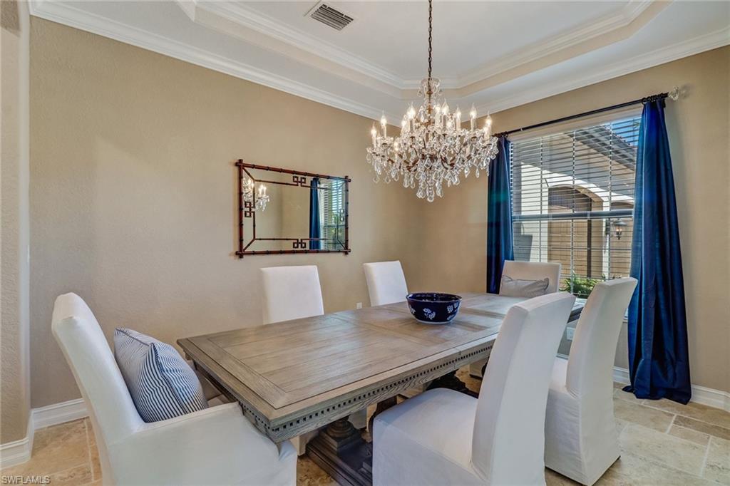 9902 Corso Bello Drive Naples, FL 34113 - Photo 3 of 45 a view of a dining room with furniture window and wooden floor