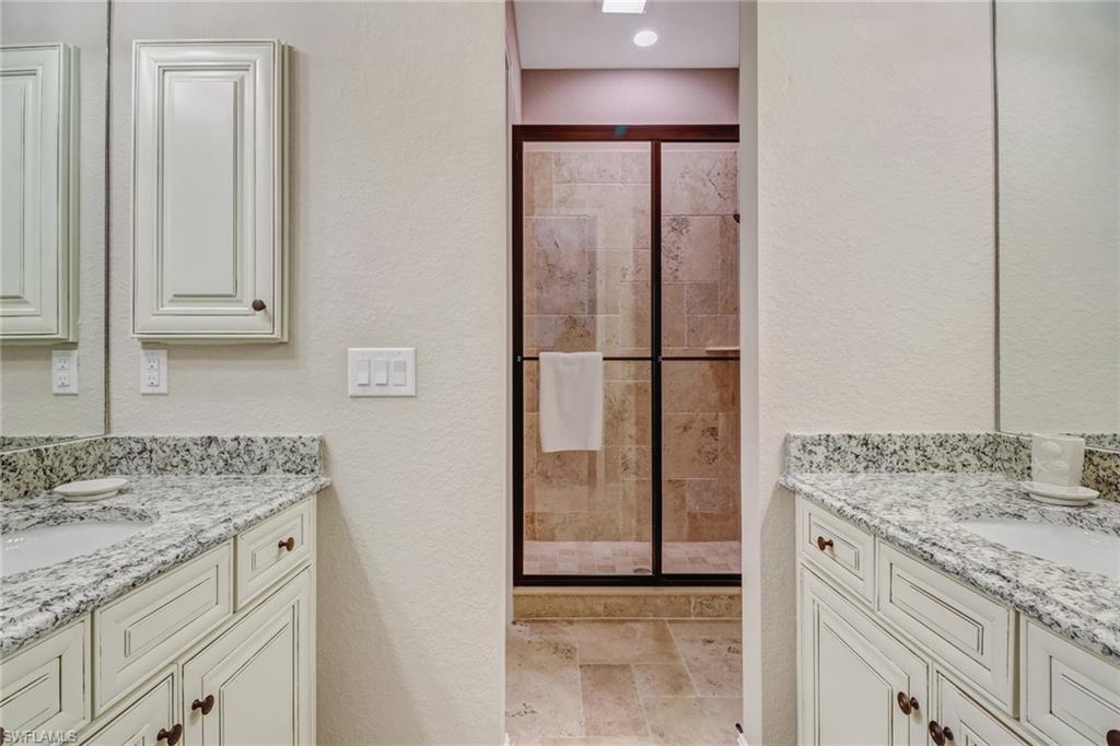 9902 Corso Bello Drive Naples, FL 34113 - Photo 31 of 45 a bathroom with a granite countertop sink and a mirror
