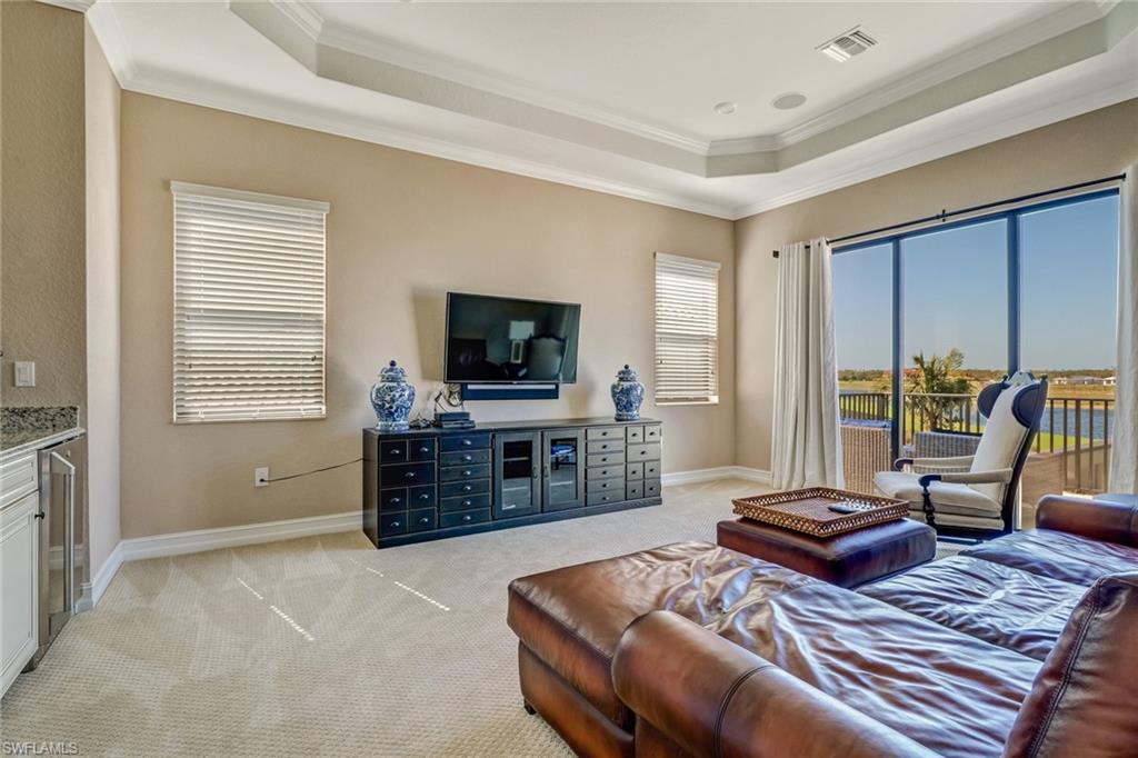 9902 Corso Bello Drive Naples, FL 34113 - Photo 35 of 45 a bedroom with furniture and a flat screen tv