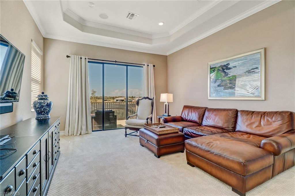 9902 Corso Bello Drive Naples, FL 34113 - Photo 37 of 45 a living room with furniture and a flat screen tv