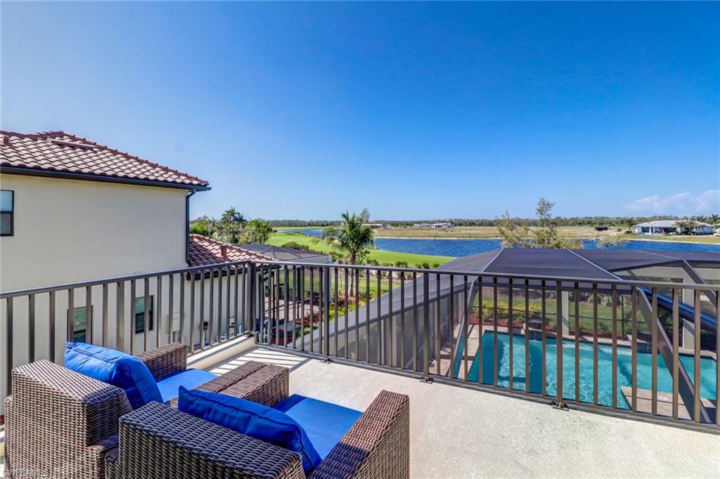 9902 Corso Bello Drive Naples, FL 34113 - Photo 38 of 45 a view of a balcony with wooden chairs