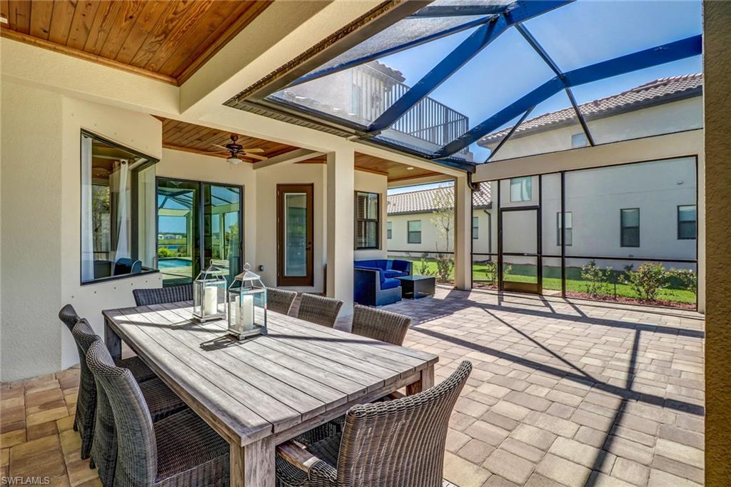 9902 Corso Bello Drive Naples, FL 34113 - Photo 43 of 45 a view of an outside dining space with furniture