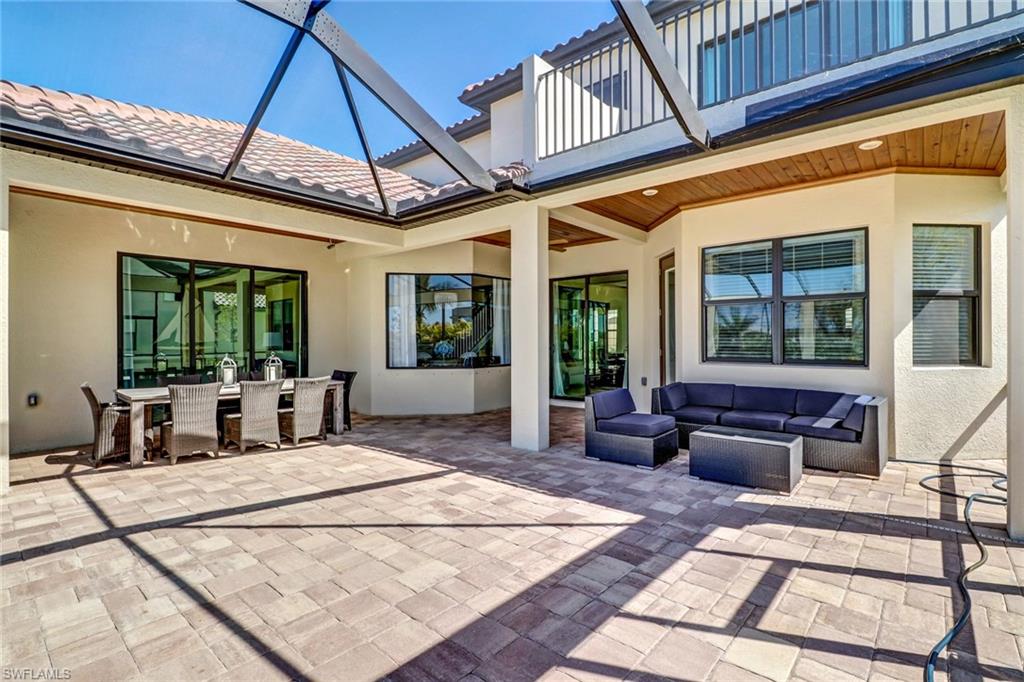 9902 Corso Bello Drive Naples, FL 34113 - Photo 44 of 45 a view of a patio with couches chairs and potted plants