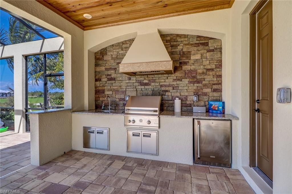 9902 Corso Bello Drive Naples, FL 34113 - Photo 45 of 45 a kitchen with a cabinets and a stove