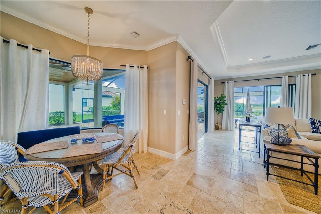 9902 Corso Bello Drive Naples, FL 34113 - Photo 7 of 45 a living room with furniture a window and a table