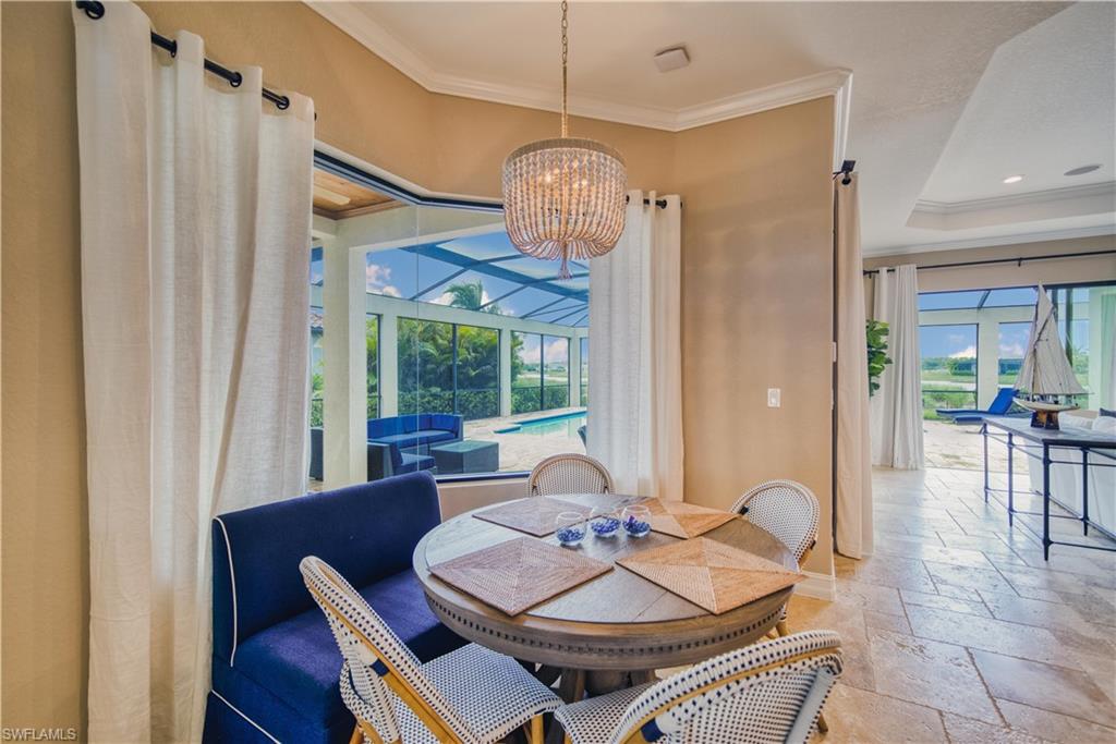 9902 Corso Bello Drive Naples, FL 34113 - Photo 8 of 45 a view of a dining room with furniture window and outside view