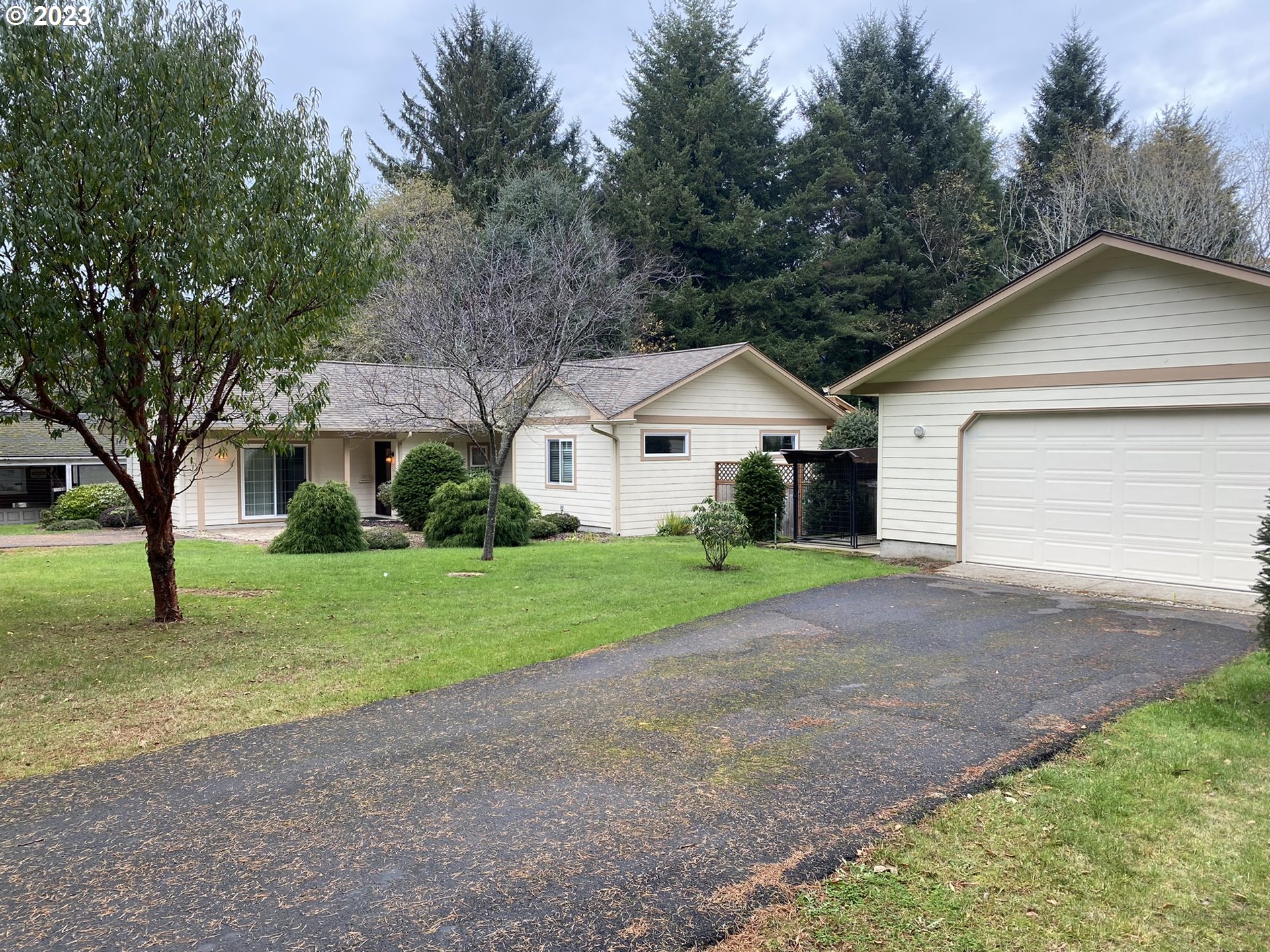 4863 Darlings Loop Florence, OR 97439 - Photo 1 of 47 a front view of a house with a yard and garage