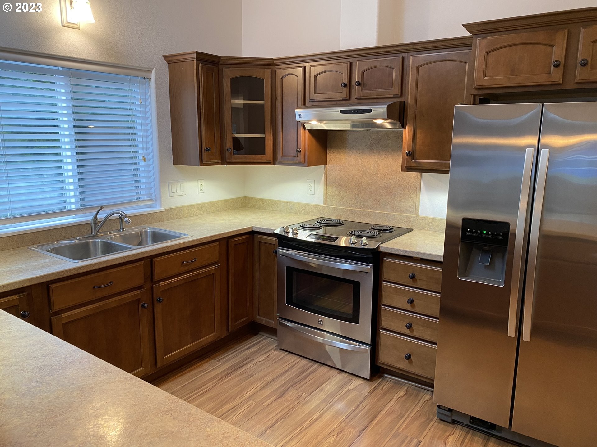 4863 Darlings Loop Florence, OR 97439 - Photo 15 of 47 a kitchen with granite countertop stainless steel appliances and wooden cabinets