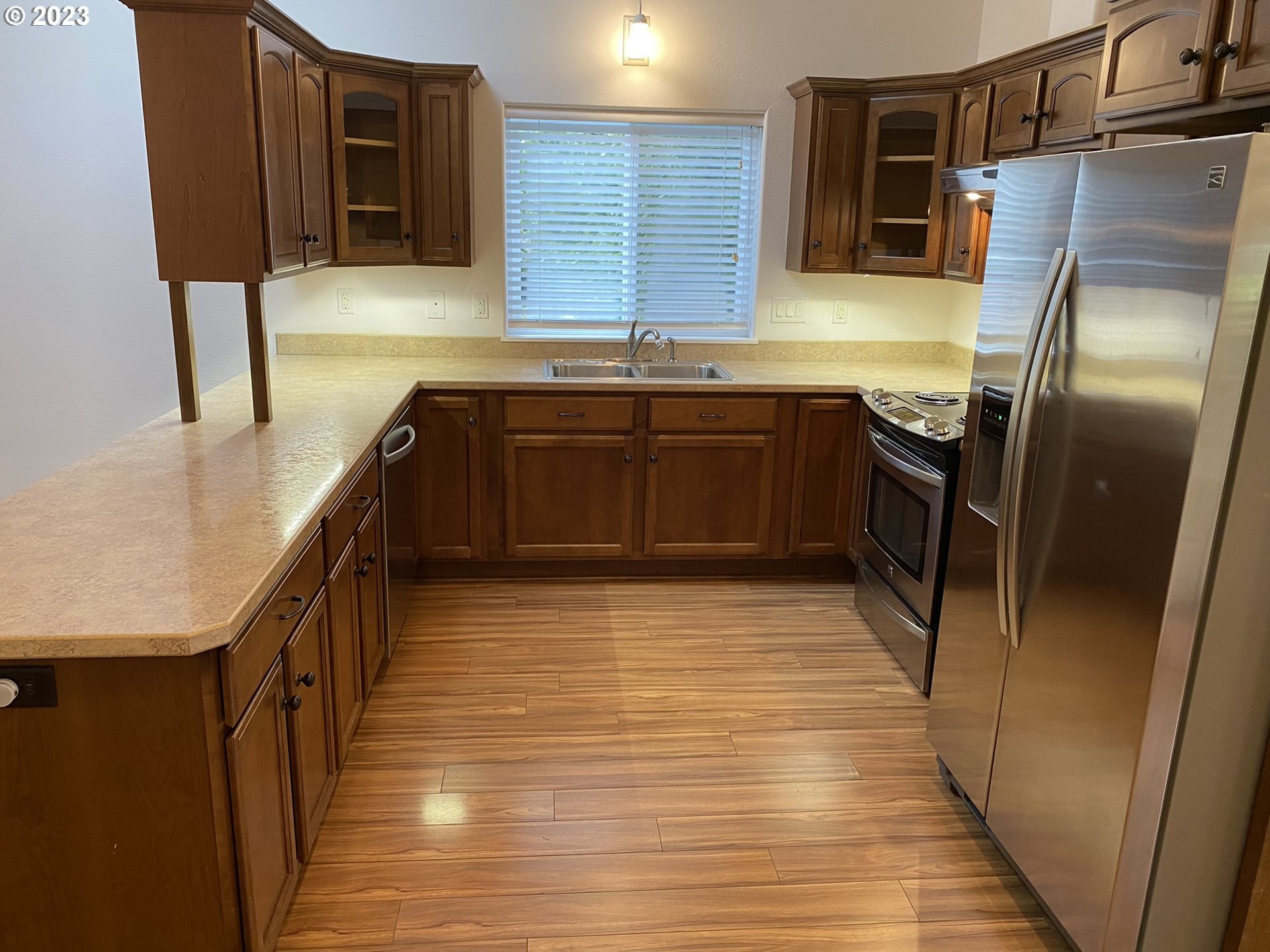 4863 Darlings Loop Florence, OR 97439 - Photo 16 of 47 a kitchen with stainless steel appliances granite countertop a sink stove and refrigerator