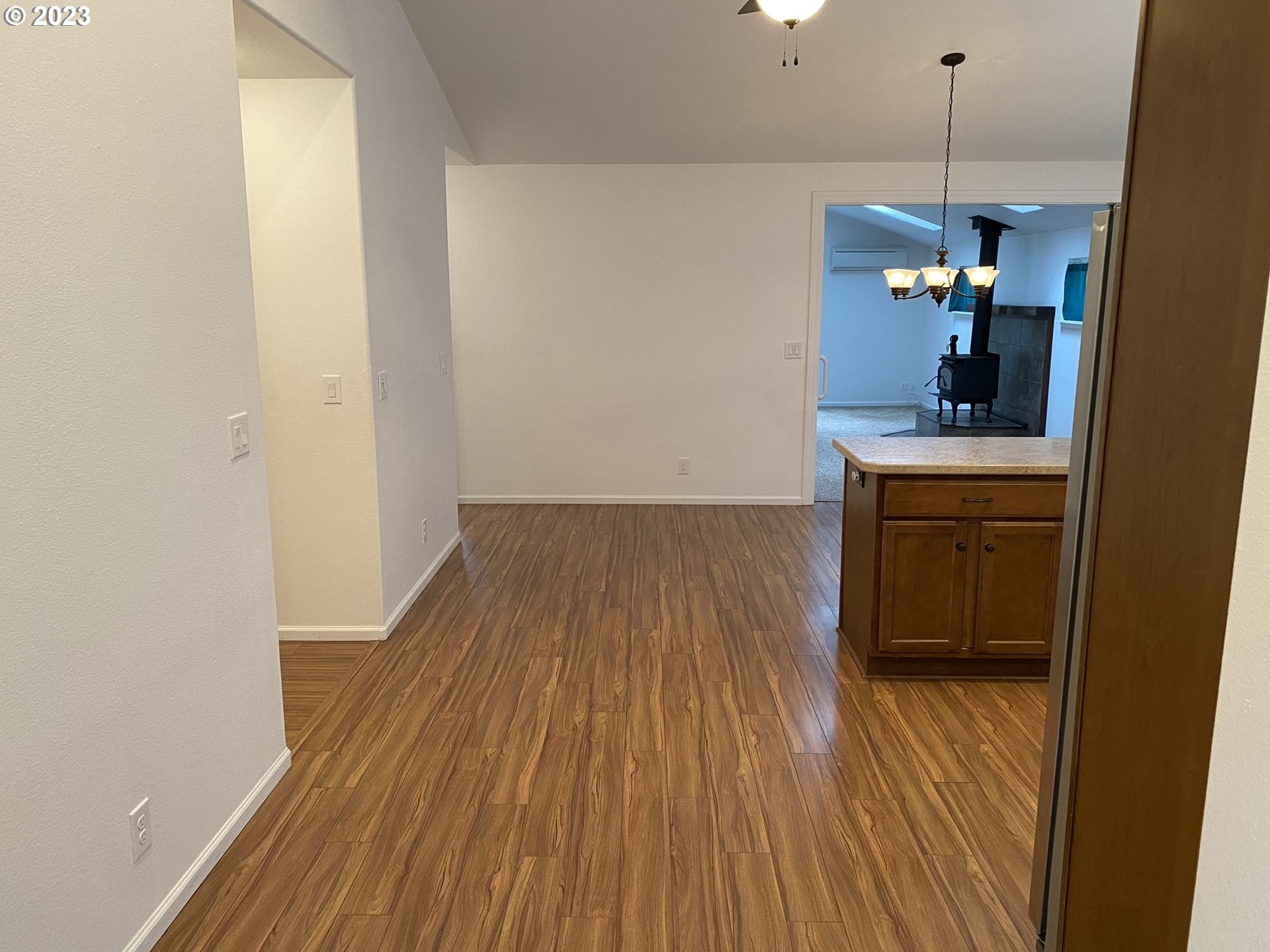 4863 Darlings Loop Florence, OR 97439 - Photo 19 of 47 a view of a hallway with wooden floor and staircase