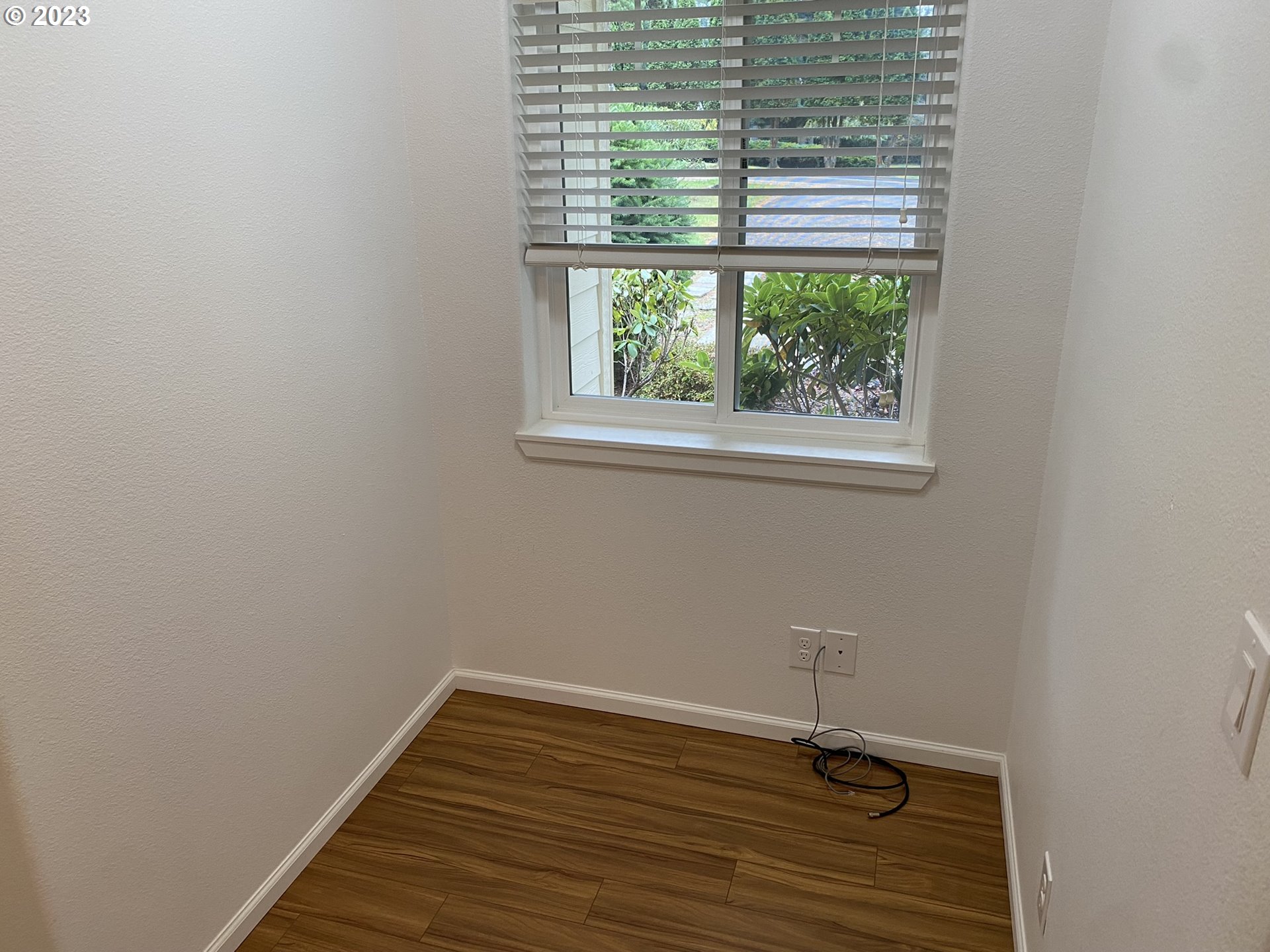 4863 Darlings Loop Florence, OR 97439 - Photo 21 of 47 a view of a small space with wooden floor and a window