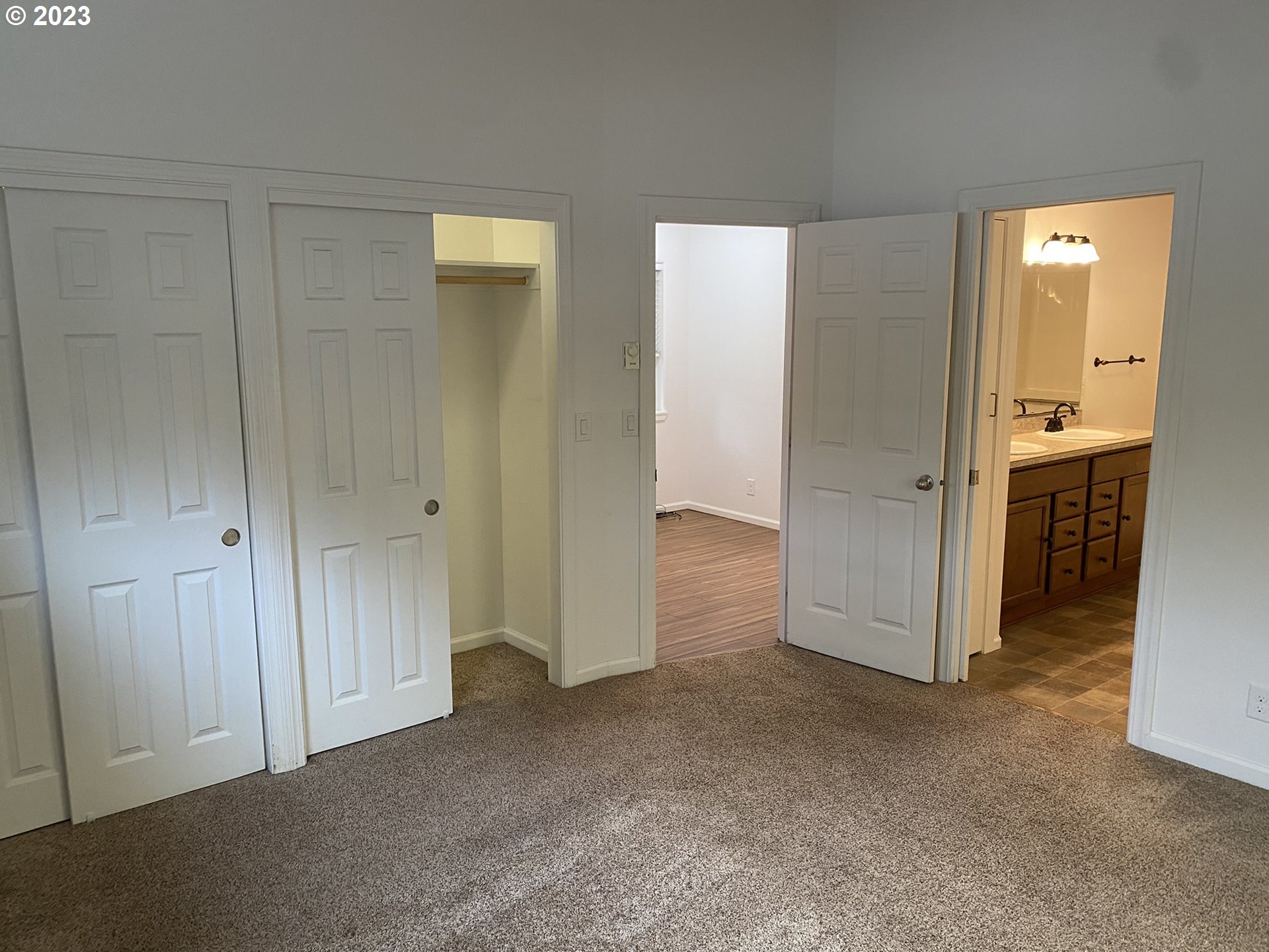 4863 Darlings Loop Florence, OR 97439 - Photo 25 of 47 an empty room with closet and mirror
