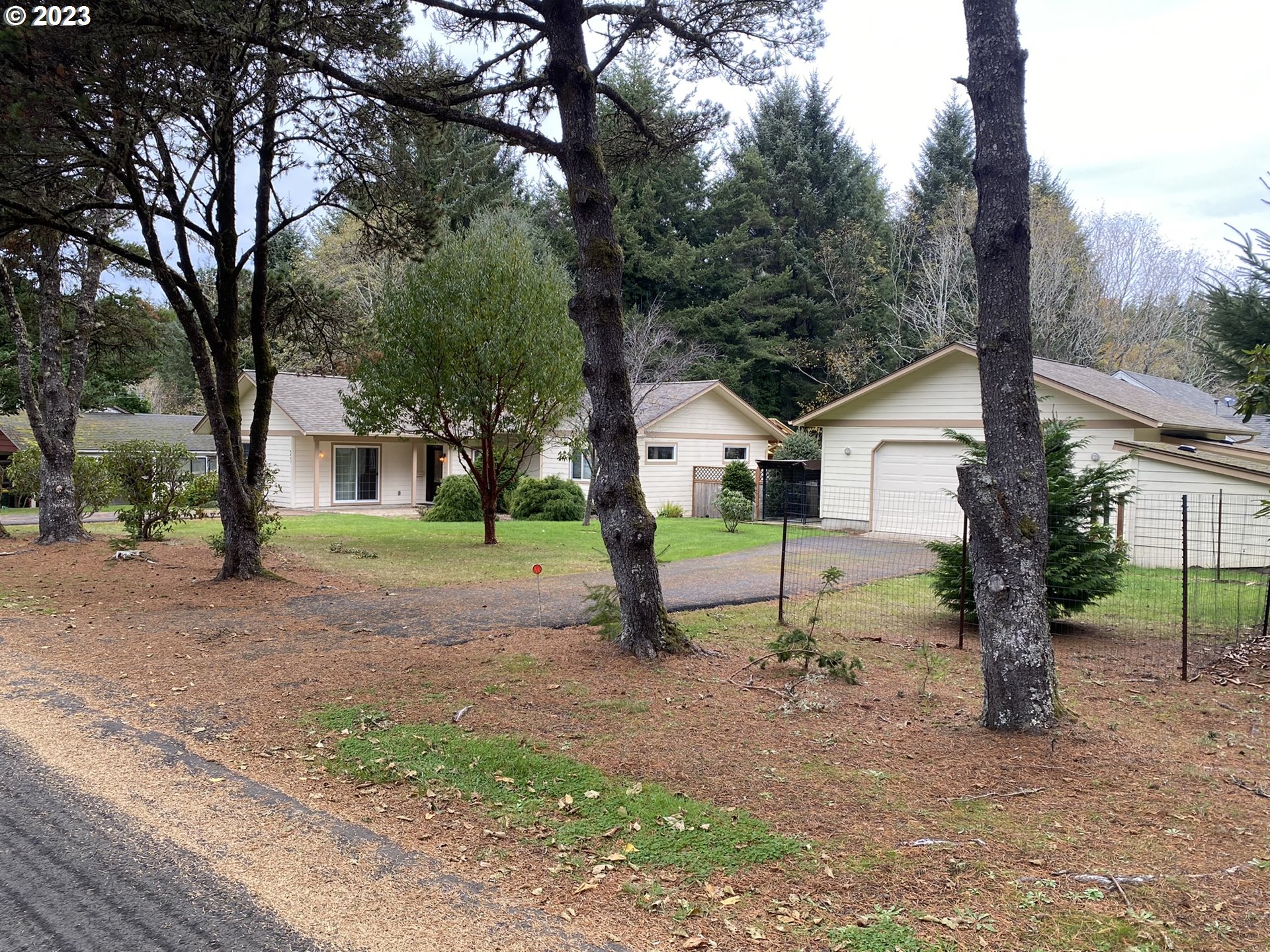 4863 Darlings Loop Florence, OR 97439 - Photo 45 of 47 a view of house with backyard and trees