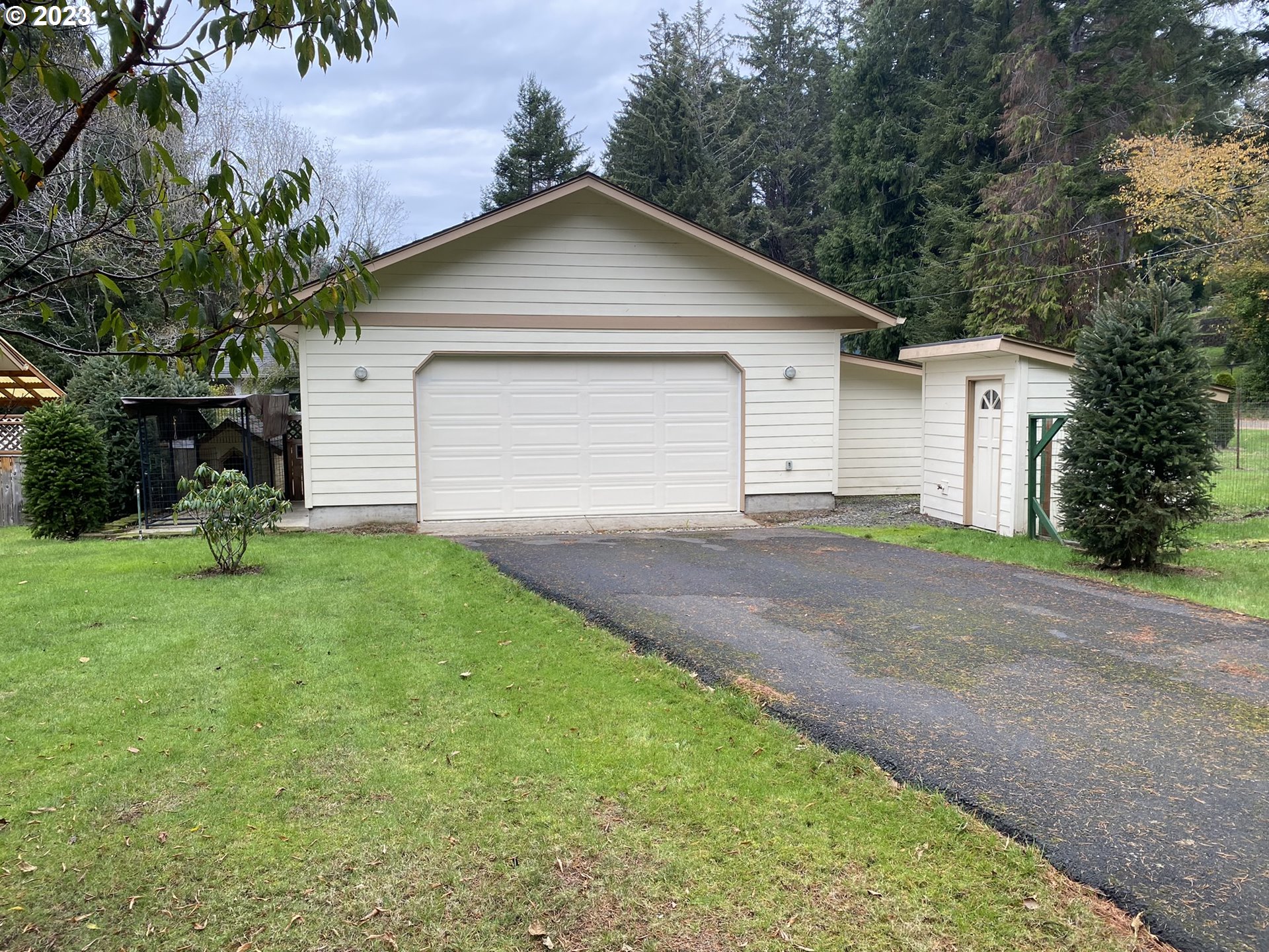 4863 Darlings Loop Florence, OR 97439 - Photo 6 of 47 a view of a house with a yard and garage