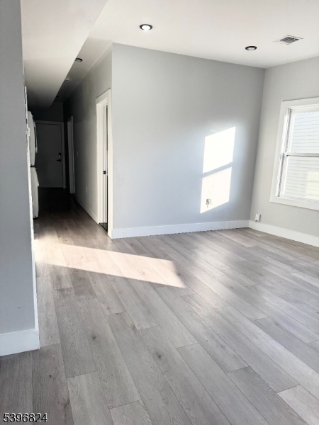 626 South 20th Street, Unit 3 Newark, NJ 07103 - Photo 4 of 12 an empty room with wooden floor and windows