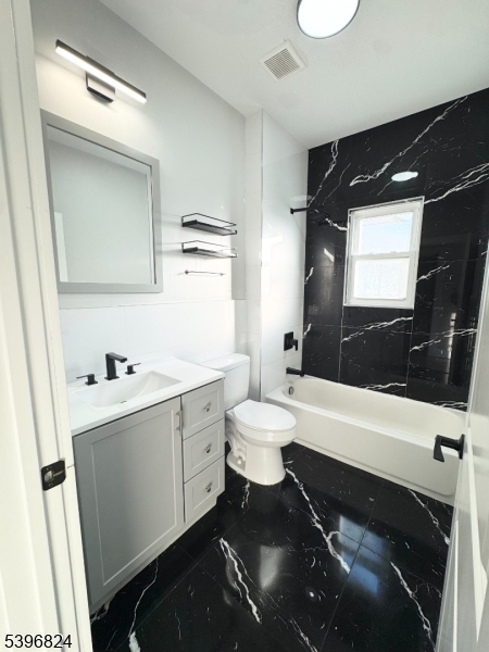 626 South 20th Street, Unit 3 Newark, NJ 07103 - Photo 5 of 12 a bathroom with a sink a toilet a mirror and a bathtub
