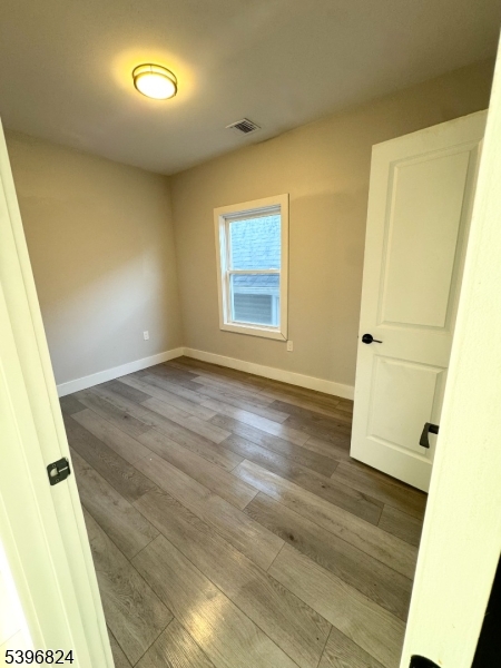 626 South 20th Street, Unit 3 Newark, NJ 07103 - Photo 6 of 12 an empty room with wooden floor and white walls