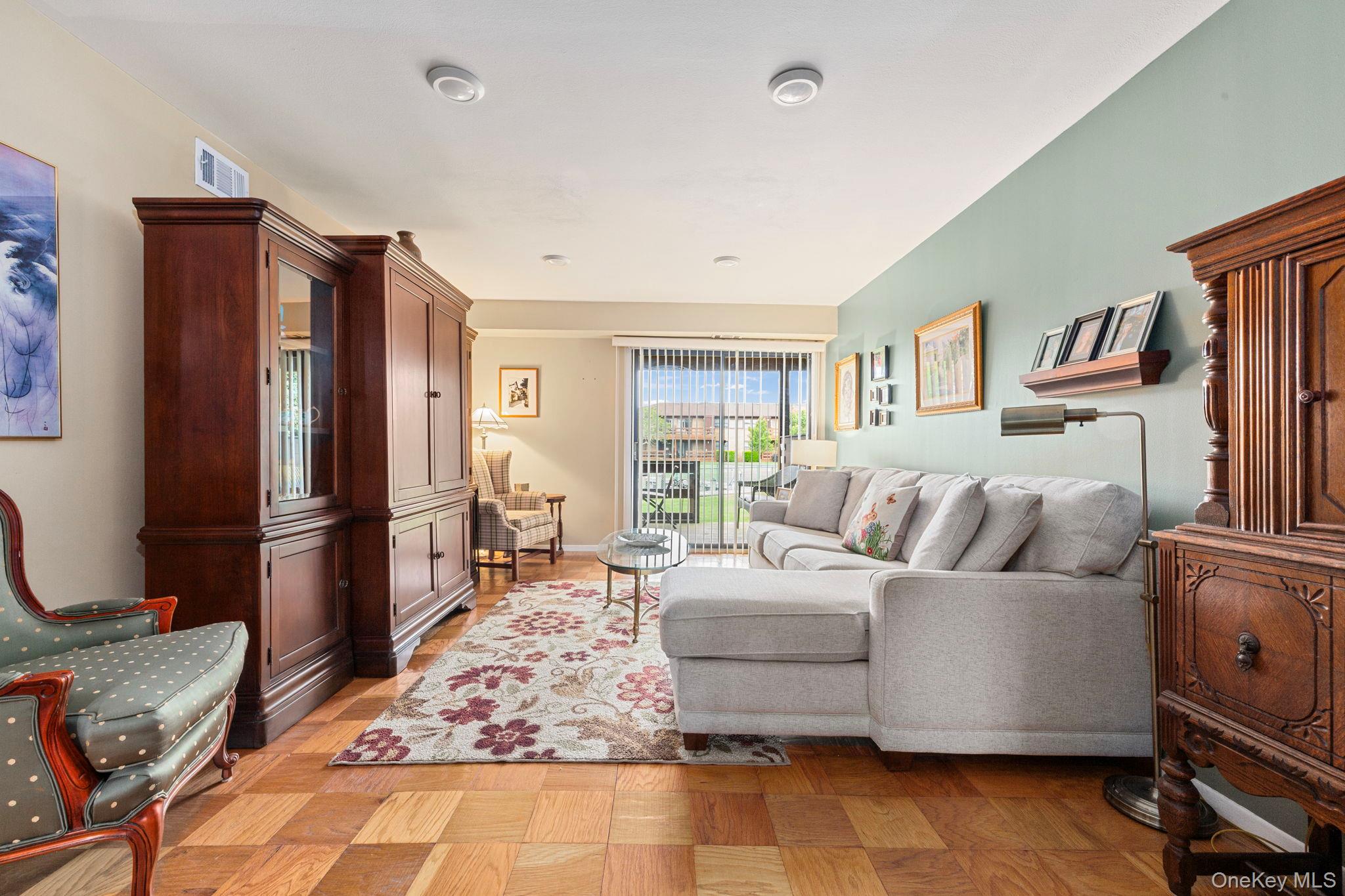 248 Mariners Way Copiague, NY 11726 - Photo 4 of 18 a living room with furniture and a flat screen tv