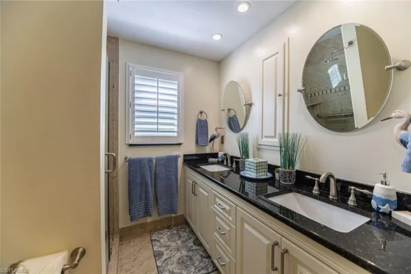 a bathroom with a double vanity sink and a mirror