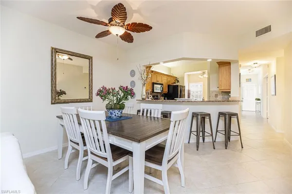 a view of a dining room with furniture and a chandelier