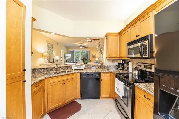 a kitchen with lots of counter top space and stainless steel appliances